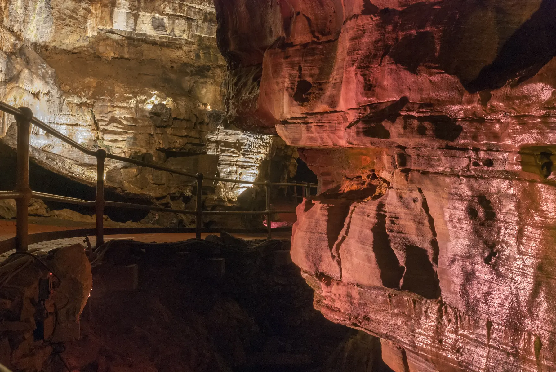 Illuminated limestone passage inside Howe Caverns